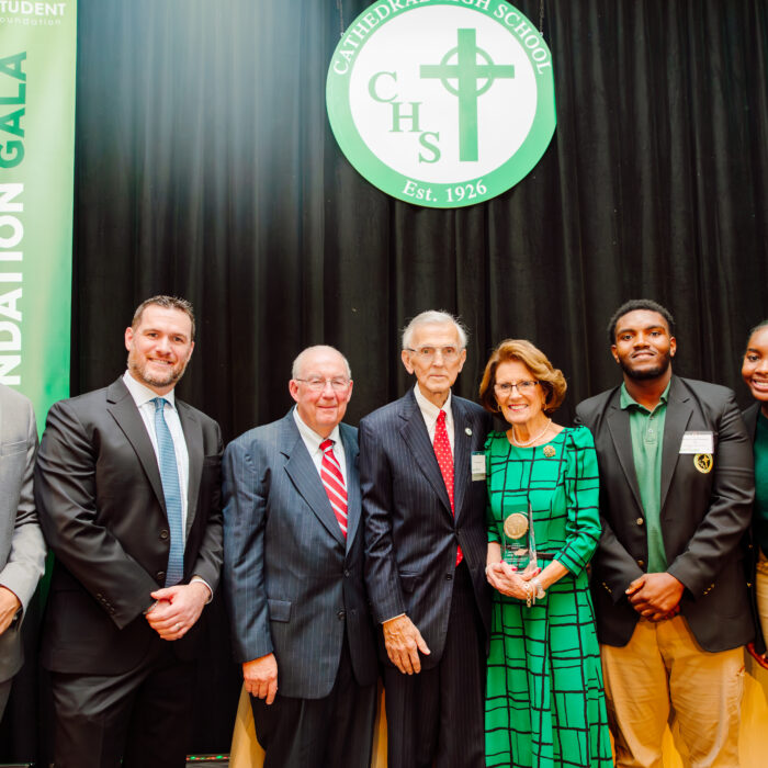Two Cathedral Scholars on stage with Principal Karl, President Dan, Paul Chisholm, C. Michael Daley ’54 and Janet Richards Daley ’55